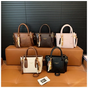 Selection of colorful leather bucket bags with vintage bead charms and logo details