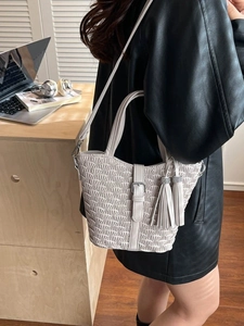Chic woven beige bucket bag with tassel and rhinestone detail for elegant women