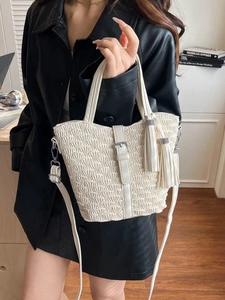 Fashionable white pleated bucket bag with tassel detail and adjustable shoulder strap