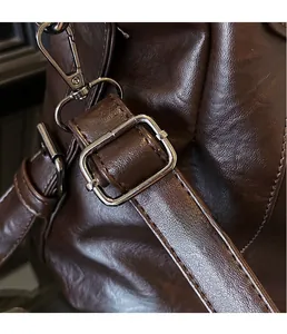 Macro detail of silver metal hardware and lychee grain leather on vintage tote bag