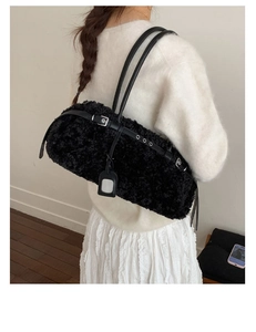 Detail of black faux fur tote bag showing plush texture and leather shoulder strap