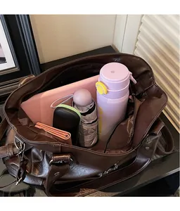 Top view of large capacity vintage tote bag interior with laptop and accessories