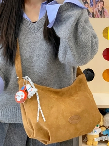 Brown matte suede tote bag for women with decorative cute plush charm on shoulder strap