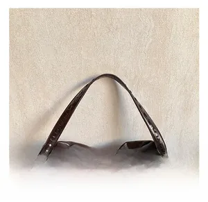 Close-up of decorative square stitching on dark brown leather tote bag handle