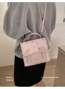 Detailed back view of a cute cartoon bear pink crossbody bag with metal buckles