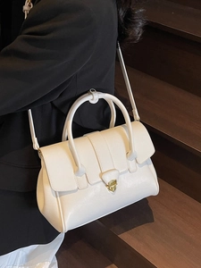 Chic white minimalist handbag with gold metal lock and shoulder strap for women