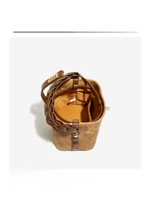 Interior view of vintage embossed bucket bag with floral pattern and leather drawstring