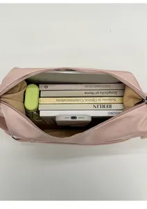Top view of the pink dumpling bag interior showing large capacity for books and umbrella