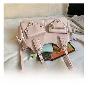 Spacious pink faux leather biker bag interior showing tablet, phone, and daily essentials