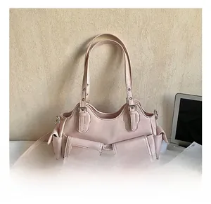 Detail view of pink leather tote bag with multi-pocket design and adjustable shoulder strap