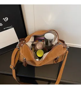 Spacious brown suede tote bag showing large interior capacity for daily essentials