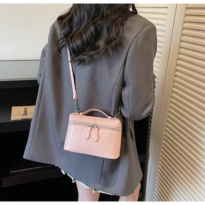 Pink ostrich texture handbag styled with grey blazer for daily commute and dating