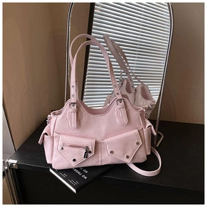 Pink Y2K utility bag featuring multi-pocket design and metallic eyelet strap detail