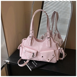 Detail of pink PU leather tote with metallic studs and functional exterior pockets