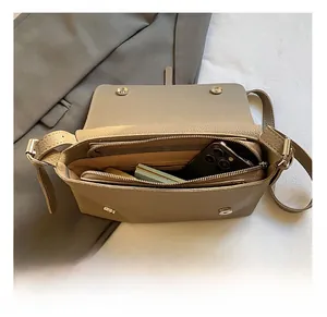 Detail view of large capacity crossbody bag interior with multiple organizational compartments