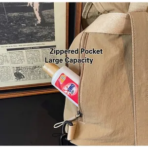 Macro view of khaki travel backpack showing side zipper pocket and nylon fabric detail