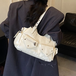 Detailed view of cream biker bag with vintage crackle leather and utility cargo pockets