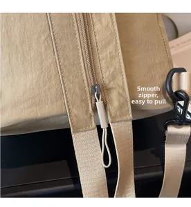 Detail shot of smooth zipper and khaki nylon fabric on a high capacity backpack