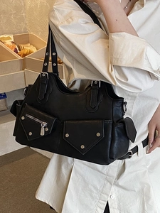 Chic black biker-style tote bag in faux leather with silver hardware and pockets