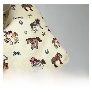 Close-up of off-white fabric with colorful cartoon graffiti and Fun Party printed pattern