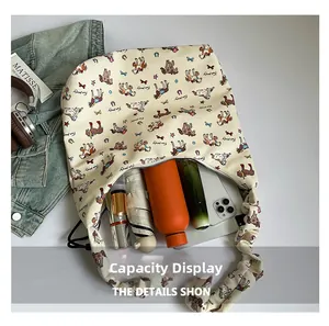 Spacious interior of canvas tote bag showing umbrella and water bottle storage