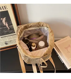 Top view detail of large khaki canvas backpack interior with zipper pocket and spacious storage