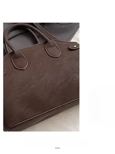 Detail view of deep brown vintage leather handbag showing soft texture and twin handles