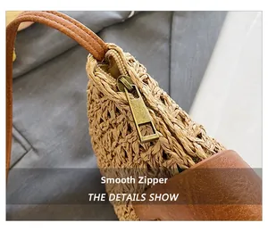 Detailed close-up of smooth bronze metal zipper on a khaki woven straw shoulder bag