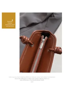 Detailed macro shot of caramel brown leather tote with metal zipper and knot strap detail