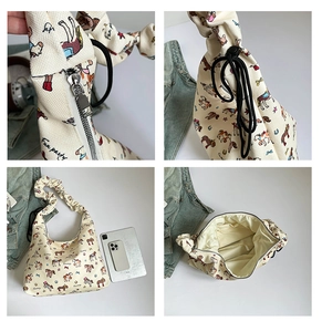 Detail view of cream canvas tote bag with cartoon horse prints and zipper close-up