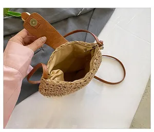 Detailed interior of woven straw crossbody bag with magnetic leather flap and fabric lining