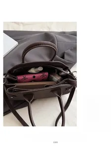 Interior view of deep brown pebbled leather bag with multiple compartments and storage space