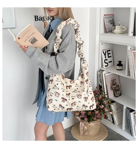 Detail of cartoon pony canvas tote bag featuring wide pleated shoulder straps and soft texture