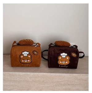 Detail of retro cylinder handbags with cartoon bear embroidery and bread plush charms