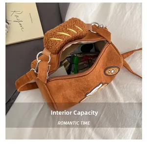 Detail view of large interior capacity for caramel brown suede crossbody bag