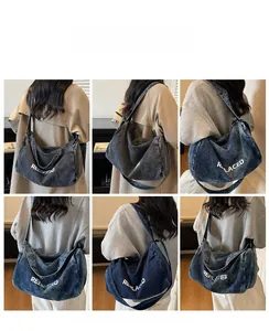 Model lifestyle shots of large blue denim tote bag with white REPLACED printed text