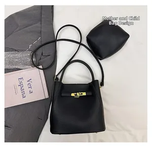 Close-up of black litchi grain bucket bag set with gold lock and mini pouch