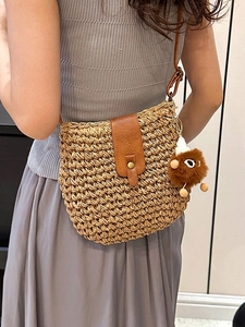 Handwoven straw crossbody bag with brown leather flap and cute plush animal charm