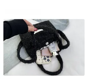 Interior view of black fleece bucket bag showing black and white checkered lining and capacity