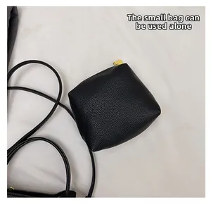 Detail of black lychee texture mini pouch with gold zipper that can be used separately