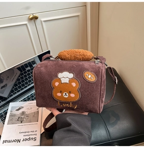 Detail of retro cylinder handbag with teddy bear embroidery and fuzzy fleece handle