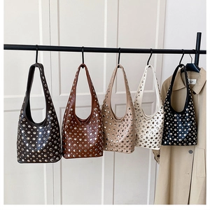 Detailed view of motorcycle style bucket bags with metal rivets in five classic colors