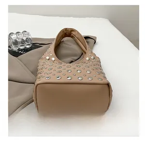 Detailed view of the wide wear-resistant bottom on khaki moon bag with silver studs