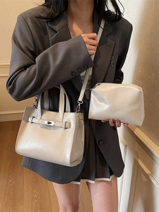 Elegant beige two-piece tote bag set with metal twist lock shown on fashion model