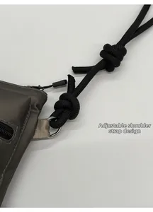 Detail of adjustable woven rope shoulder strap and metal D-ring on nylon bag
