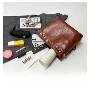 Spacious dark brown quilted tote showing daily essentials like phone and makeup