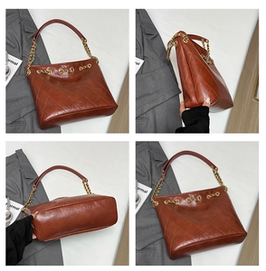 Detail view showing brown quilted leather texture and gold chain strap of the tote bag