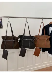 Detailed display of large matte tote bags in dark brown, black and caramel colors