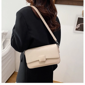 Minimalist cream white crossbody bag with classic flap and tonal square buckle detail