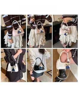 Chic women's crossbody bags in pink, white, and black with cute bear charms on models
